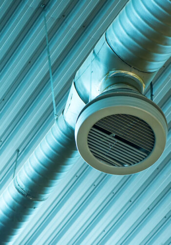 Industrial ventilation system pipes on warehouse ceiling